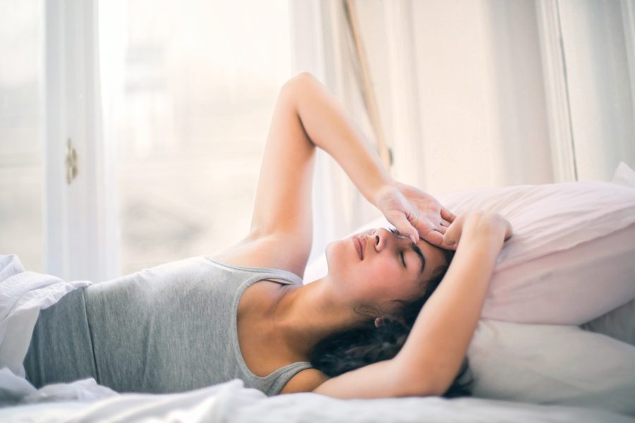 woman-in-gray-tank-top-sleeping-on-white-bed-3769008